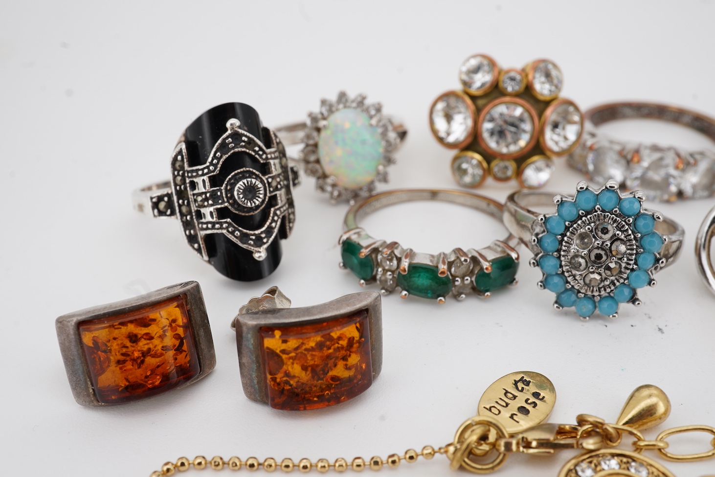 Assorted jewellery including a 925, black onyx and marcasite set Art Deco style ring, three other 925 rings, a pair of 925 amber ear studs and a 925 brooch, together with four costume rings and a costume bracelet.